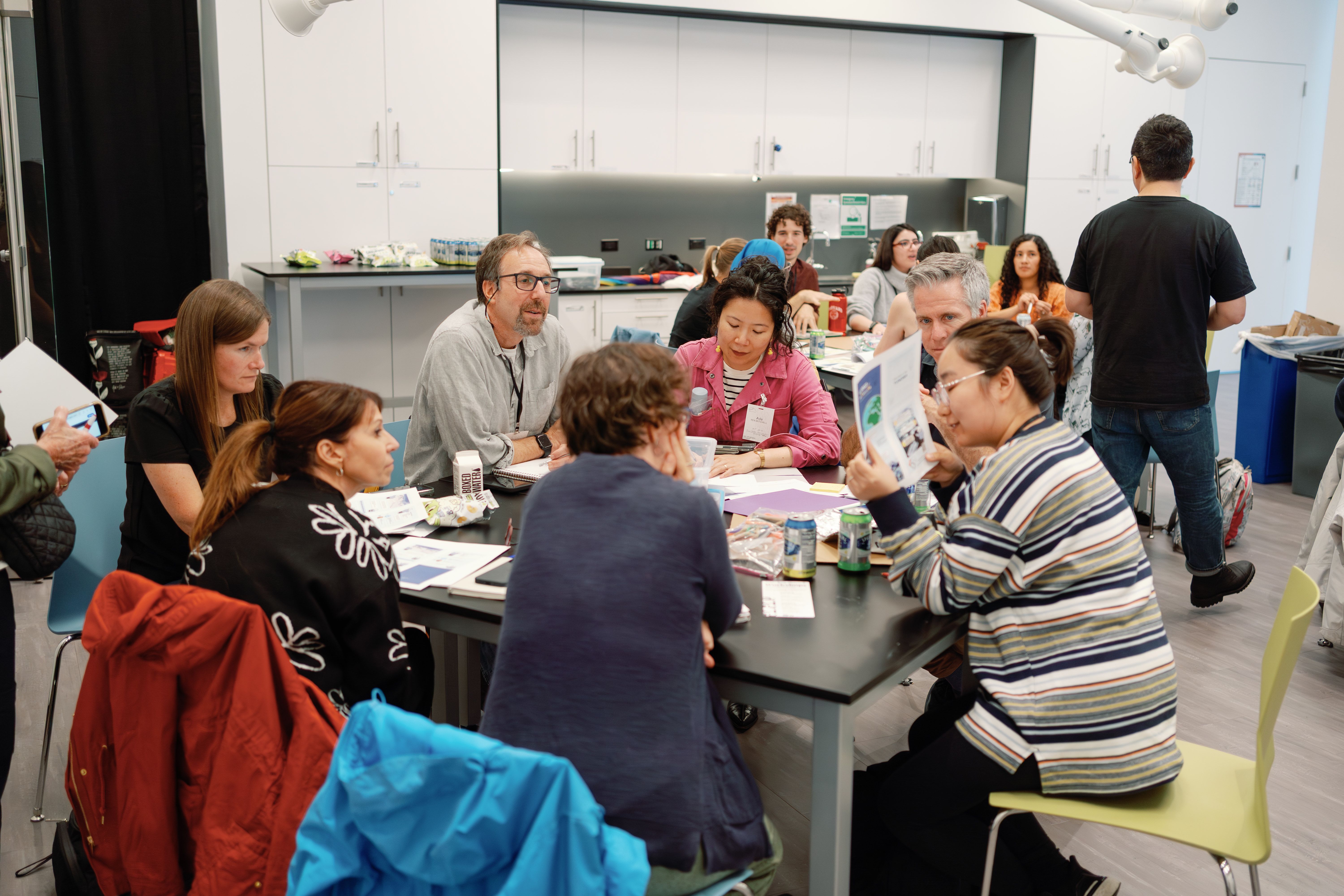 A small group discusses their project at a table.